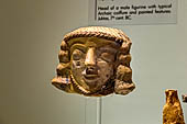 Museo archeologico di Iraklion.  Head of a male figurine with typical archaic coiffure and painted features. Juktas, 7th c. BC. 